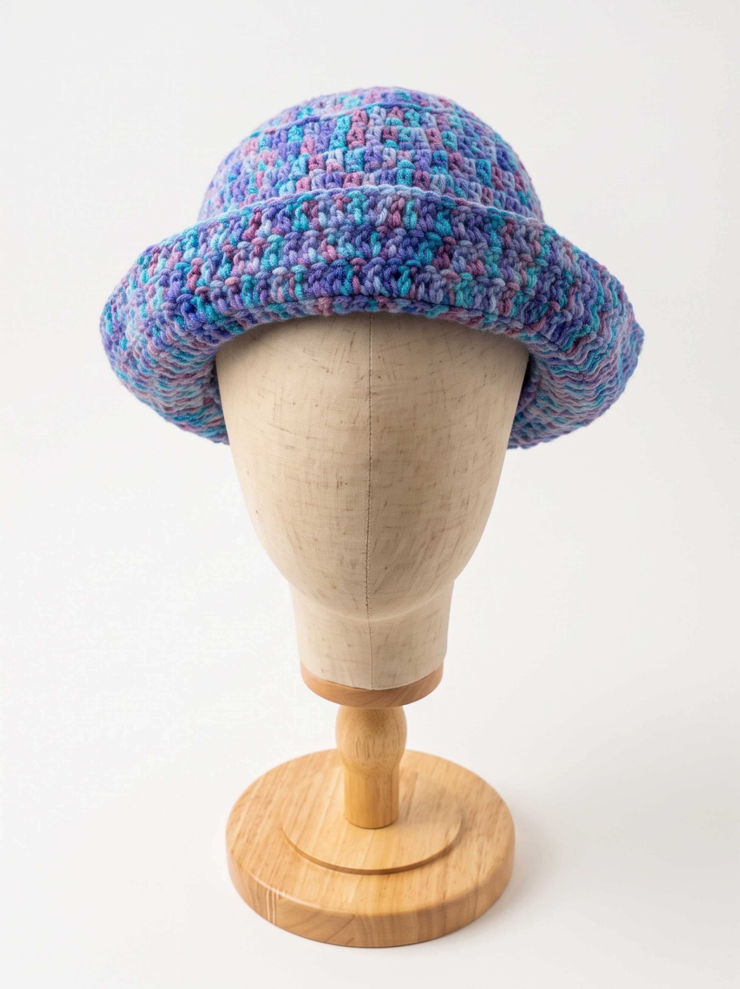 Blue, purple, and teal marled crochet rolled-brim bucket hat